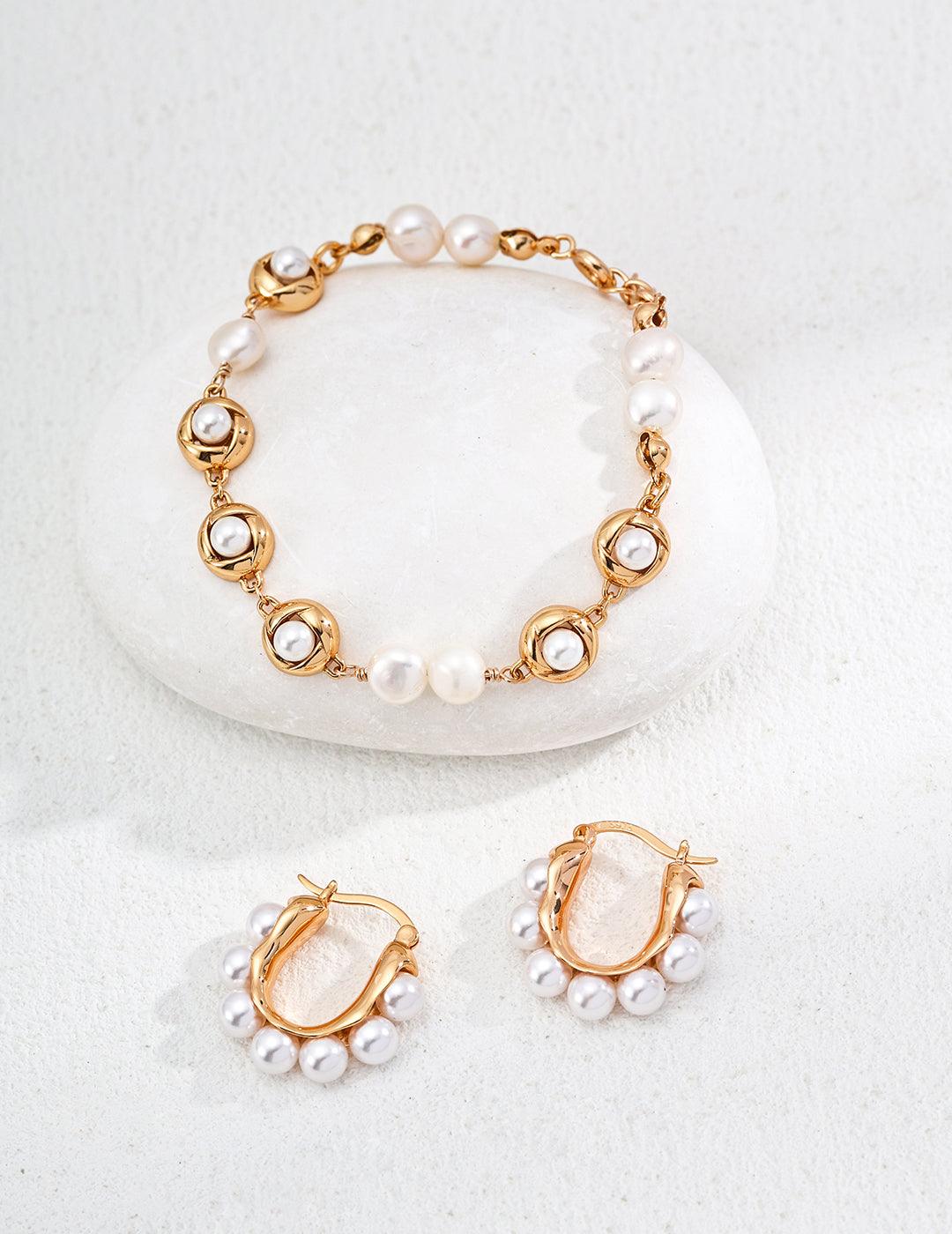 Silver Hoop Earrings-Radiant Pearl Huggies in Gold - Xaxa&Si. Discover the perfect balance of elegance and simplicity with these S925 sterling silver hoops, enhanced by lustrous imitation pearls.