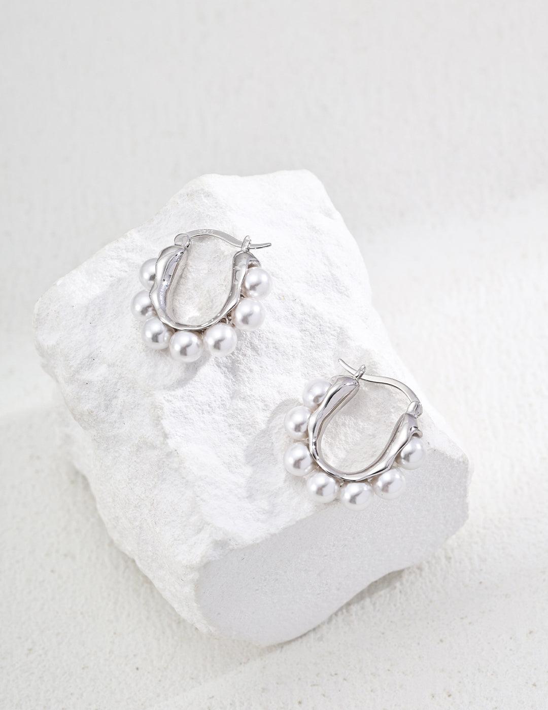 Silver Hoop Earrings-Radiant Pearl Huggies in Gold - Xaxa&Sie. Light up your look with these delicate sterling silver hoops, designed to showcase luminous imitation pearls for subtle everyday glamour.