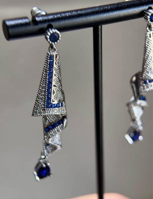 Sparkling blue cubic zirconia earrings featuring sophisticated spiral design, perfect for formal events.