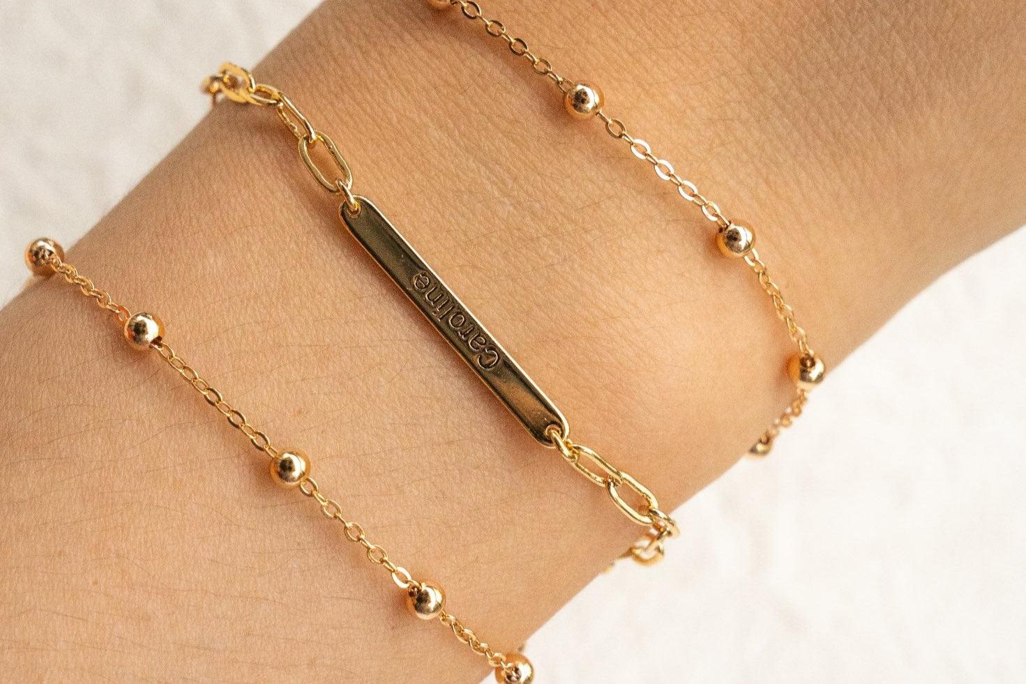 Stylish gold bracelet featuring a square pendant, perfect for casual or formal wear
