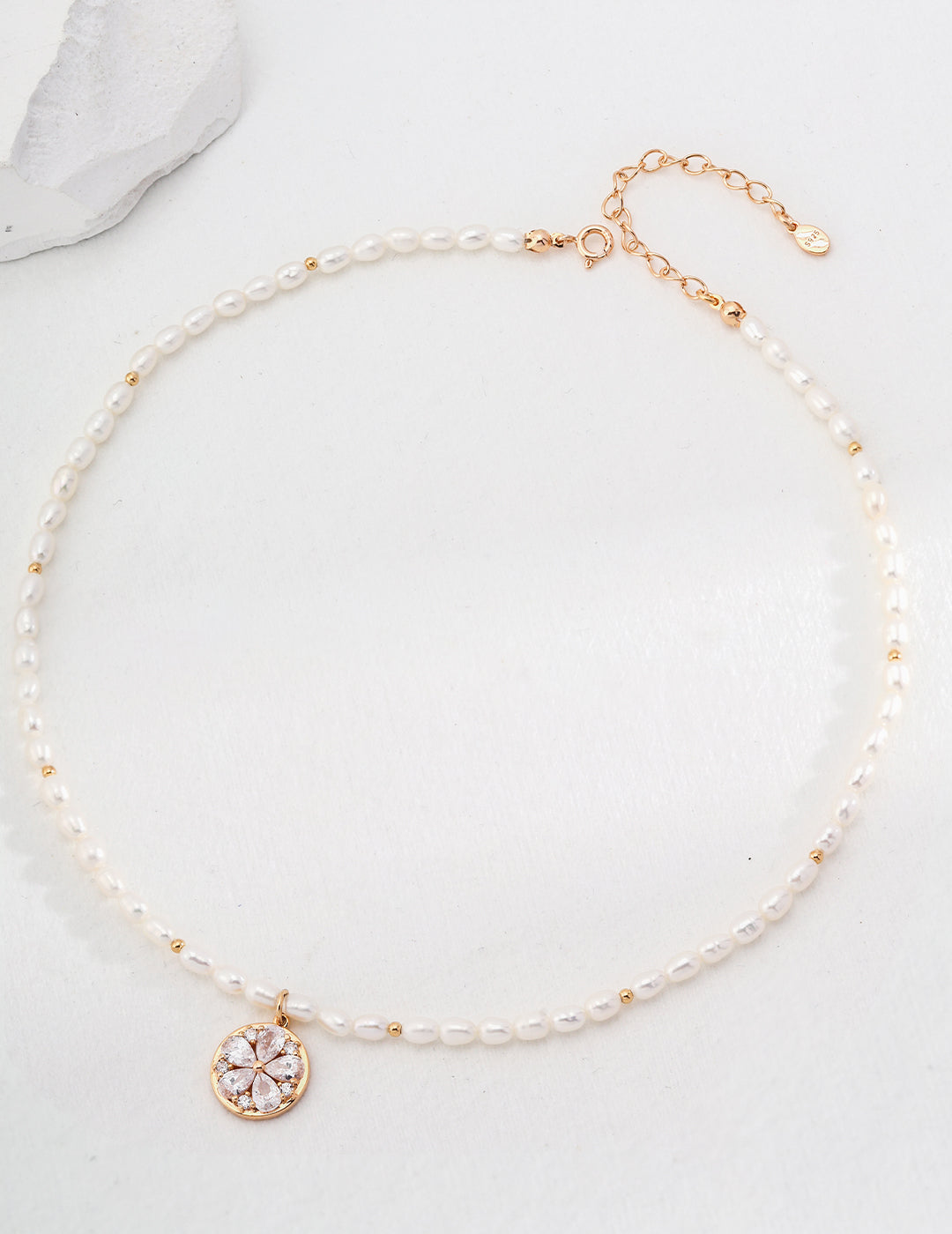 Delicate pearl necklace with a vintage-inspired gold charm, ideal for special occasions