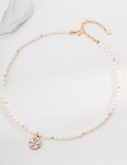 Delicate pearl necklace with a vintage-inspired gold charm, ideal for special occasions