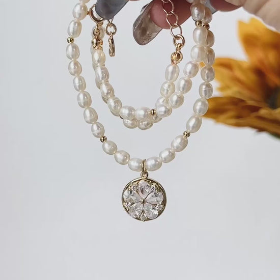 A timeless pearl necklace with a dainty gold pendant, designed for elegance and grace.